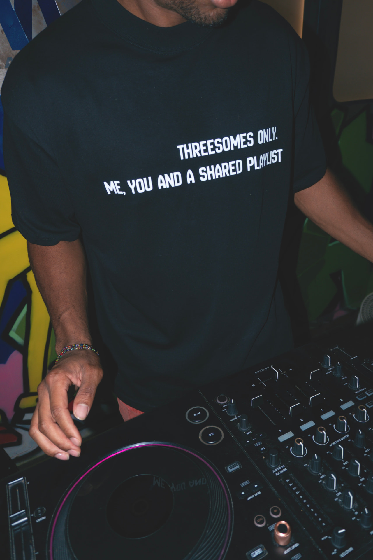 Close-up of the Threesomes Only Tee print at the controller